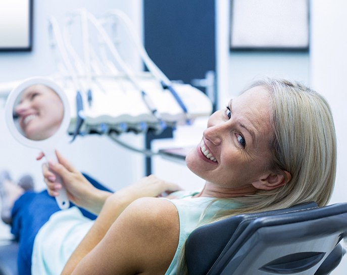 Smiling woman looking in mirror