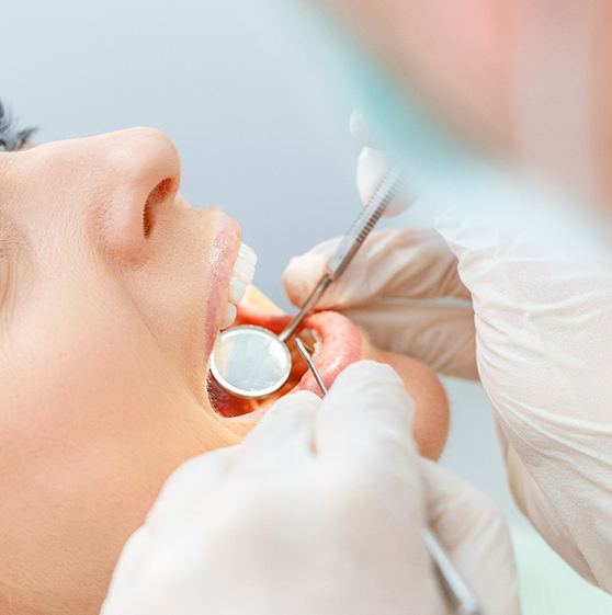 Dentist examining woman’s teeth