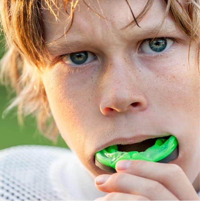 Teen with green athletic mouthguard
