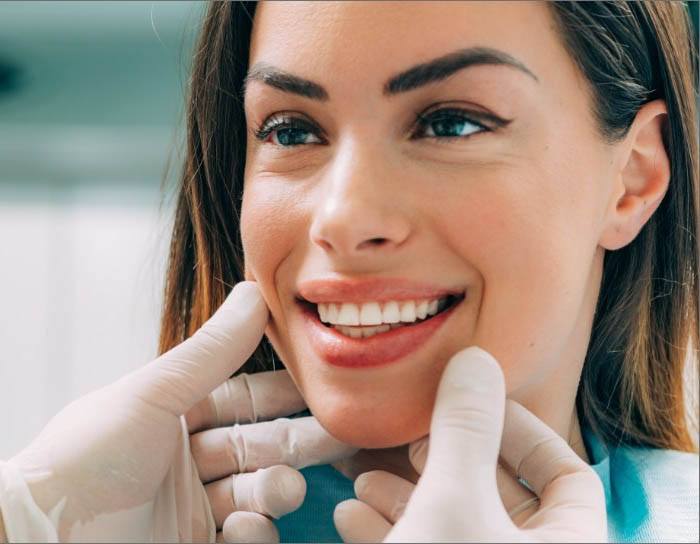 Dentist examining patient's smile