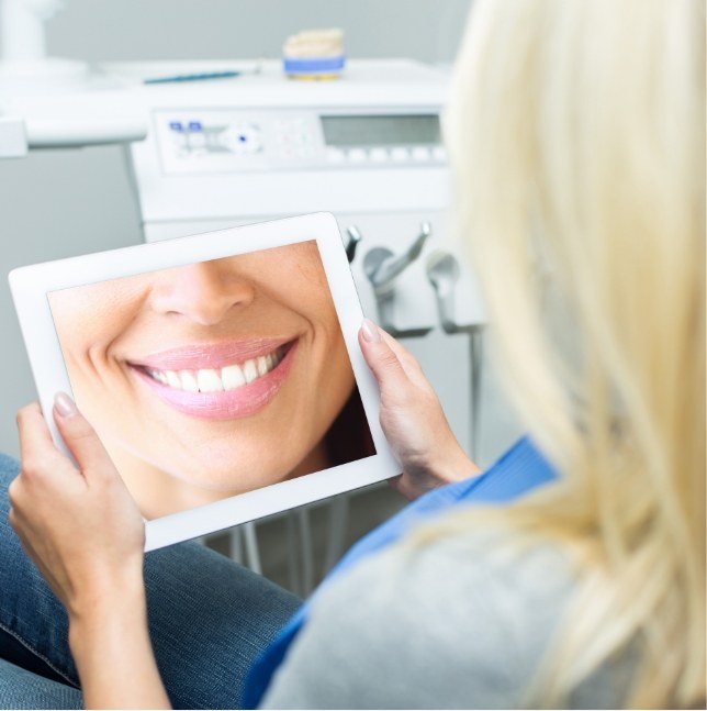 Woman looking at smile on tablet computer