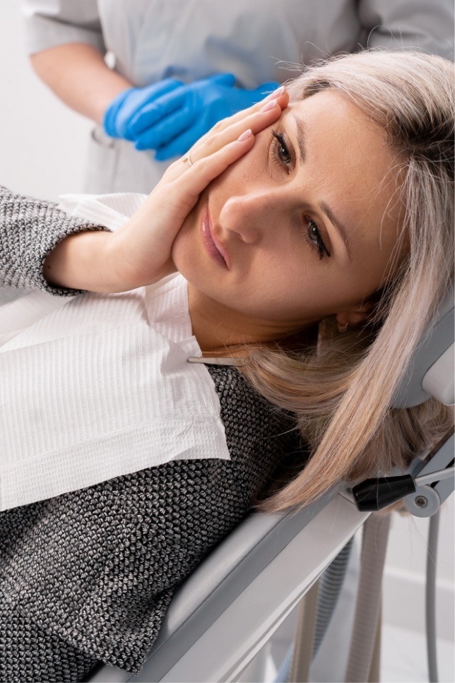 Woman in pain holding her cheek