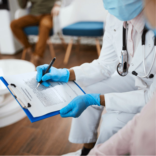 Dentist looking at clipboard with dental patient