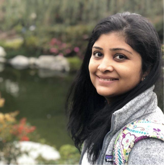 Doctor Patil smiling on a walk outdoors