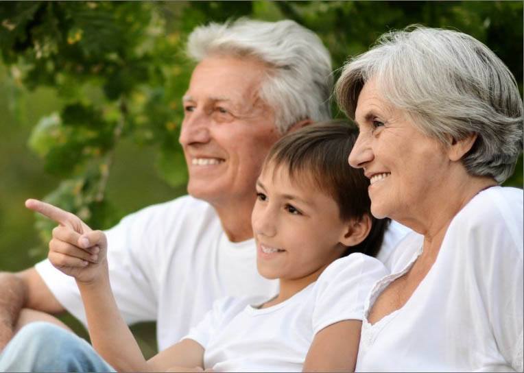 Grandparents smiling with grandchild