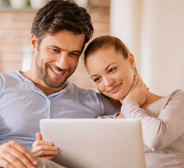 Man and woman looking on their computer