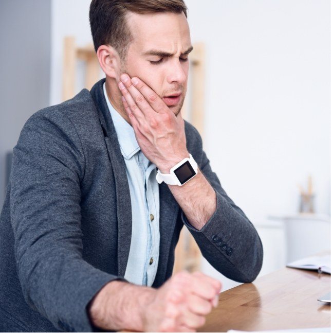 Man holding his jaw in pain