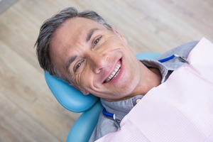 Male dental patient laying back in chair