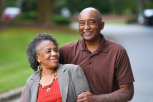 a senior citizen couple smiling with healthy and beautiful teeth